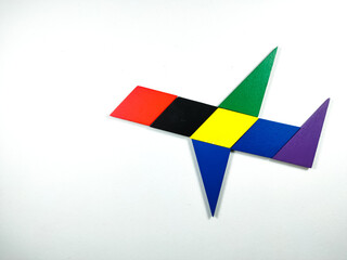 Color wood puzzle in plane shape on white background with copy space.