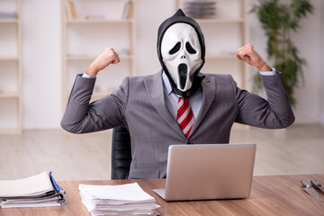 Devil businessman employee sitting at workplace