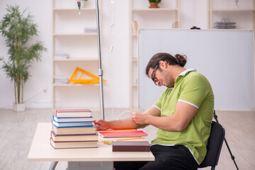 Young sick male teacher student in blood transfusion concept