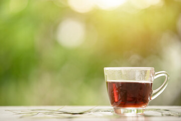 Hot tea on green background