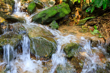 Small brook on the rock stone near the waterfall.