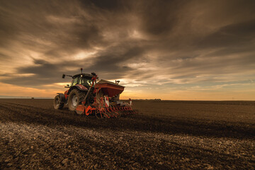 Farmer with tractor seeding