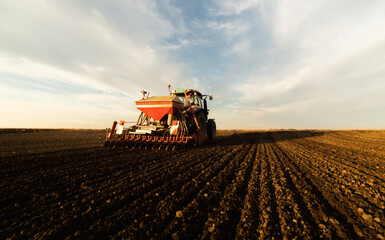 Fototapeta premium Farmer with tractor seeding