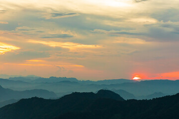 Sunset or evening time over the mountains hill valley with beauty clouds.
