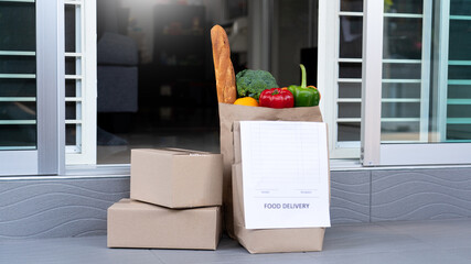 Business concept A wife house picking the bag full of the colorful vegetable delivered during her...