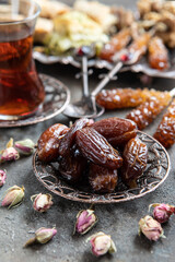 Turkish tea in traditional glass with sweet dates