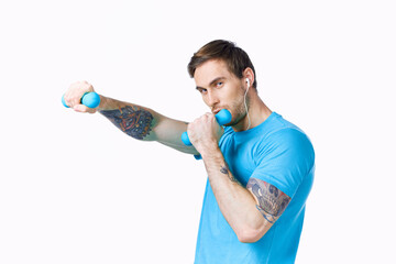 man with dumbbells in hands workout fitness light background exercise