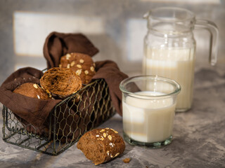 Black bread with seeds and milk, on a light background.Rural style