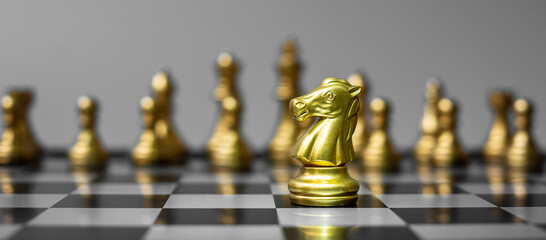 gold Chess knight figure Stand out from the crowd on Chessboard background. Strategy, leadership, business, teamwork, different, Unique and Human resource management concept