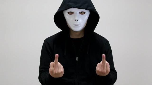 Hacker with anonymous mask showing his middle fingers