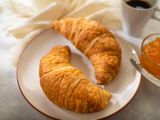 Morning breakfast. Coffee croissants, jam, milk. French style. Sunlight. Restaurant and hospitality business