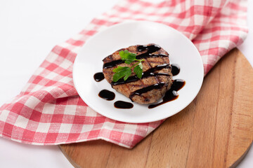 Grilled beefsteak and vegetables on a white background
