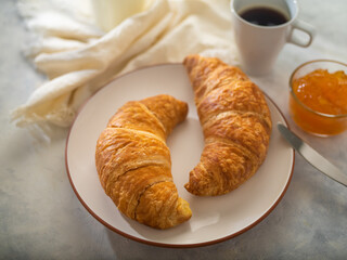 Morning breakfast. Coffee croissants, jam, milk. French style. Sunlight. Restaurant and hospitality business