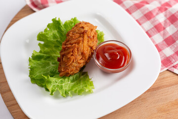 Two juicy meat cutlets close-up on a natural wooden background.