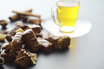 Chocolate bars on a black background in backlight. Chocolate with filling. Sweet sweets for snack and tea.