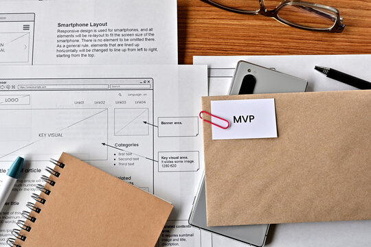 There Is Card With The Word MVP On It With Dummy Paper Of Design Of Web Systems.