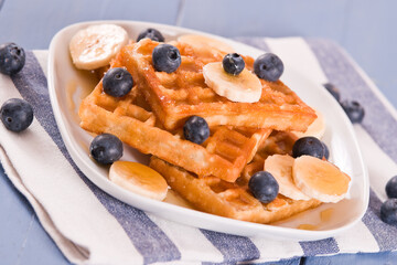 Waffles with blueberries, bananas and honey.