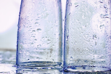 Background with tall glasses for sparkling wines. Champagne and spray in glass glasses. Celebratory drink with reflection.