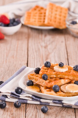 Waffles with blueberries, bananas and honey.