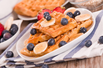 Waffles with blueberries, bananas and honey.