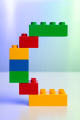 Fototapeta premium the letter C built from toy brick letters 