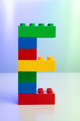 the letter E built from toy brick letters 