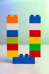 the letter U built from toy brick letters 