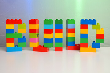 The word BUILD built from toy brick letters 