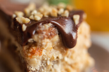 Appetizing chocolate cake. Drops of chocolate drip down the side of the cake. Detail of a cream cake with chocolate. White cake with chocolate topping.