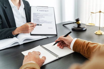 Lawyer preparing to sign a contract reading documents at meeting