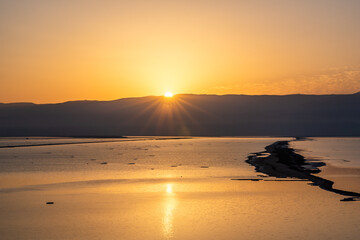Golden sunrise over the Jordanian mountains at the Dead Sea in Israel