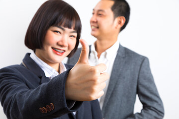 Happy business man and woman showing thumb up over white background.
