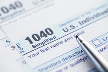 Annual tax reporting. Tax form on the table. Financial statements for signature.