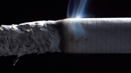 Footage of smoldering cigarette on black background
