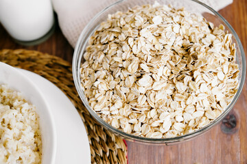 Porridge and apple with cinnamon. Oatmeal. Top view, space for text. Wooden background. A white plate.