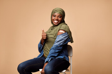 Black Muslim Lady Vaccinated Against Covid-19 Showing Like Gesture, Studio