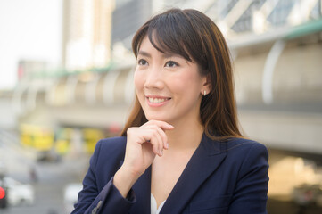 Portrait of beautiful young asian business woman is working in modern city