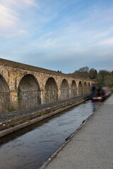 Chirk aqueduct and viaduct on the Llangollen canal, on the border of England and Wales. With a barge narrowboat crossing