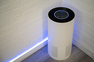 White UV-C air purifier filters viruses and pollutants from indoor air