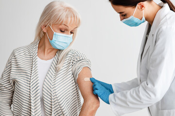 Mature Patient Getting Vaccinated Against Covid-19, Doctor Applying Plaster