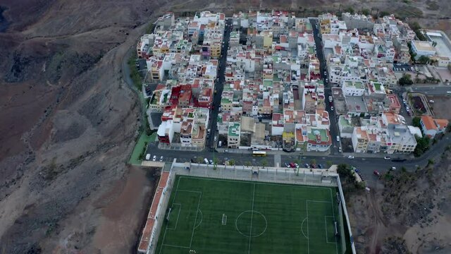 4K UHD | Tilting Aerial of a village and a soccer field
