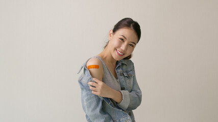 Young attractive beautiful asia female or teenage receive covid-19 anti virus vaccine in campaign...