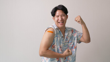 Adult mature attractive handsome asia hipster male after shot receive covid-19 anti virus vaccine...