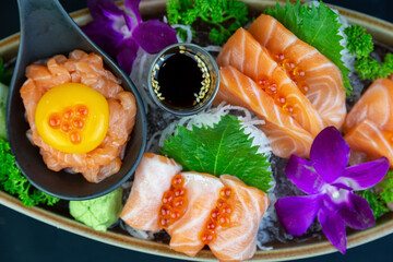Japanese seafood set consisting of salmon fillet, salmon roe, oba leaves, orchid flower