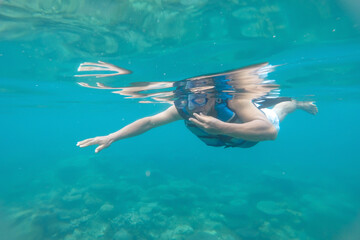 Fototapeta na wymiar A man swimming on the coral reef at a beach