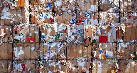 stack of old waste paper in front of a recycling plant