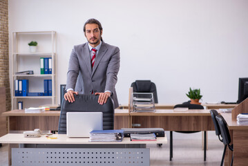 Young male employee working in the office