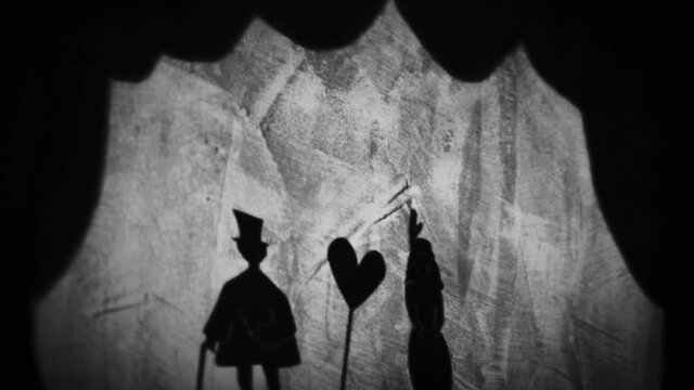 Vintage animation, shadow theatre on a wall. Pantomime, fantasy story. Halloween scene, black and white storytelling. Classic fable for children, creepy puppets.