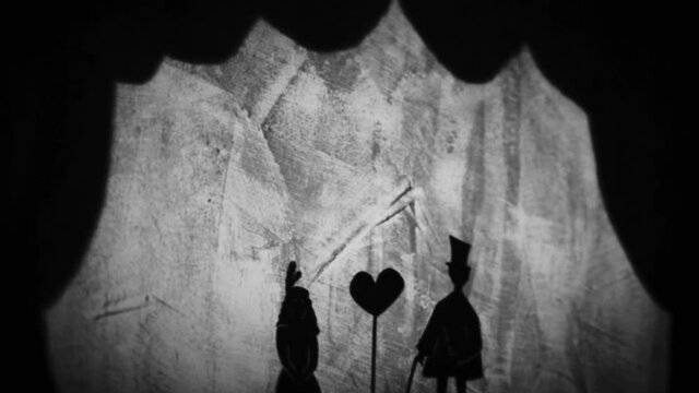 Vintage animation, shadow theatre on a wall. Pantomime, fantasy story. Halloween scene, black and white storytelling. Classic fable for children, creepy puppets.