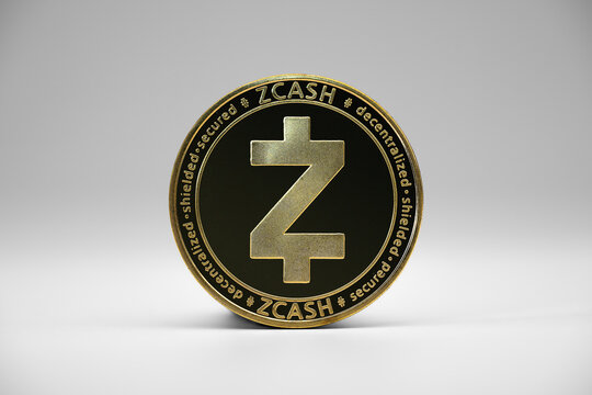 Treviso, Italy - May 1, 2021: Close up view of Zcash gold coin with white background. Virtual coins. Zcash is a cryptographic currency and a peer-to-peer payment system.